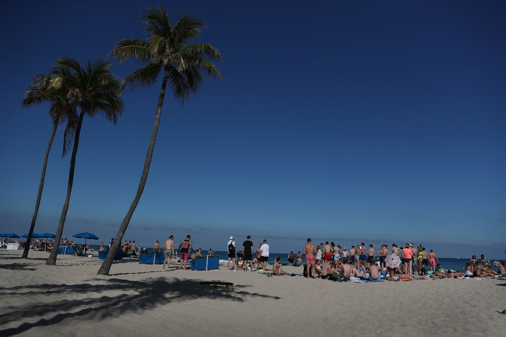 FORT LAUDERDALE, FLORIDA - MARCH 04: People walk on the beach on March 04, 2021 in Fort Lauderdale, Florida. College students have begun to arrive in the South Florida area for the annual spring break ritual. City officials are anticipating a large spring break crowd as the coronavirus pandemic continues. They are advising people to wear masks if they cannot social distance. (Photo by Joe Raedle/Getty Images)
