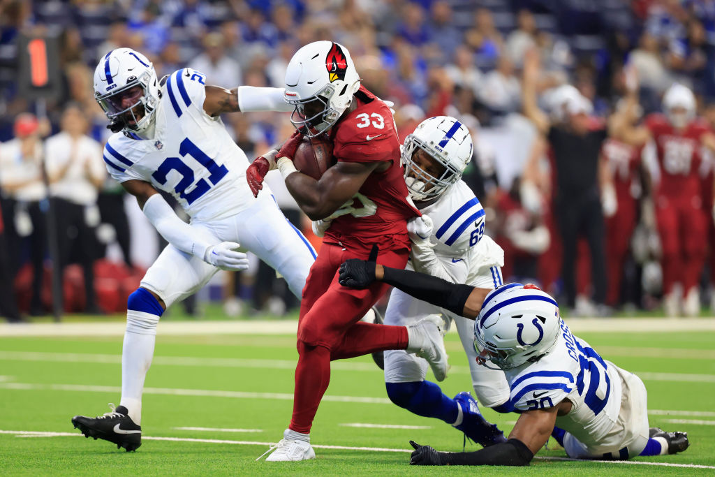 INDIANAPOLIS, INDIANA - AUGUST 17: Trey Benson #33 of the Arizona Cardinals runs the ball against Dallis Flowers #21, Derek Rivers #69, and Nick Cross #20 of the Indianapolis Colts during the first half at Lucas Oil Stadium on August 17, 2024 in Indianapolis, Indiana. (Photo by Justin Casterline/Getty Images)